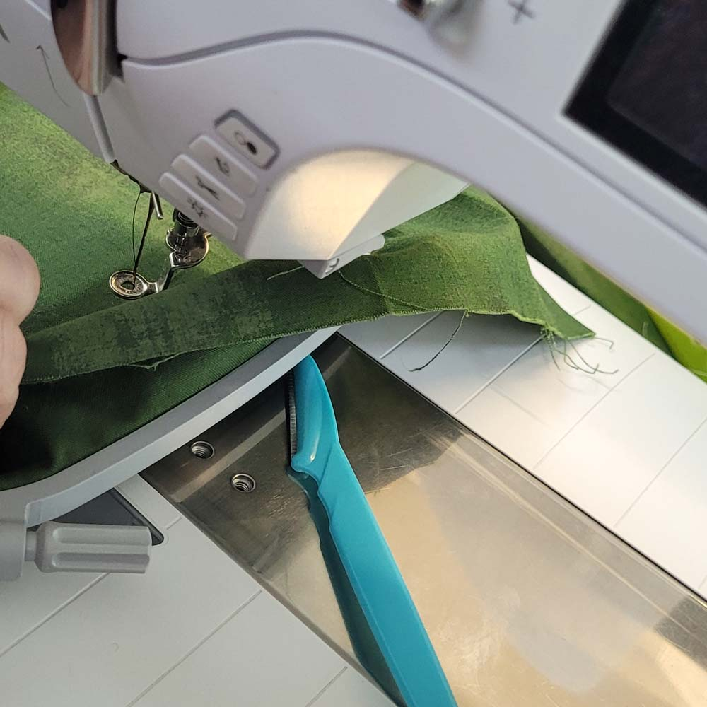 Birds Nest Tool in Use Preventing Thread Nesting Under Sewing Fabric