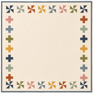 Cream quilt with a double border featuring multicoloured pinwheel blocks along the top and bottom and plus sign blocks along the sides, in muted tones of navy, pink, gold, sage, blue-grey, and terracotta, with a slate blue binding