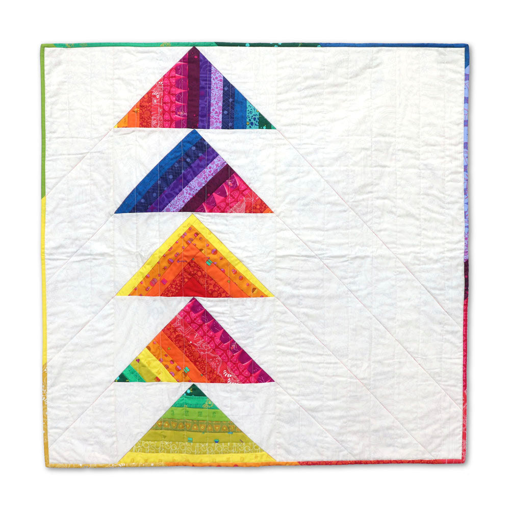 Rainbow strip-pieced flying geese quilt with five stacked triangle blocks in vibrant multicolour batik fabrics on a white background, finished with a rainbow striped binding