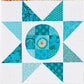 AccuQuilt GO! Circle shape appliqued as a patchwork centre in a teal pieced star quilt block
