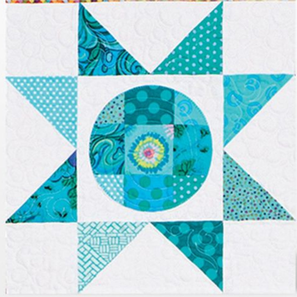 AccuQuilt GO! Circle shape appliqued as a patchwork centre in a teal pieced star quilt block